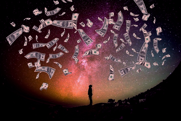 Silhouetted man standing in the dark as it's raining money with galactic background